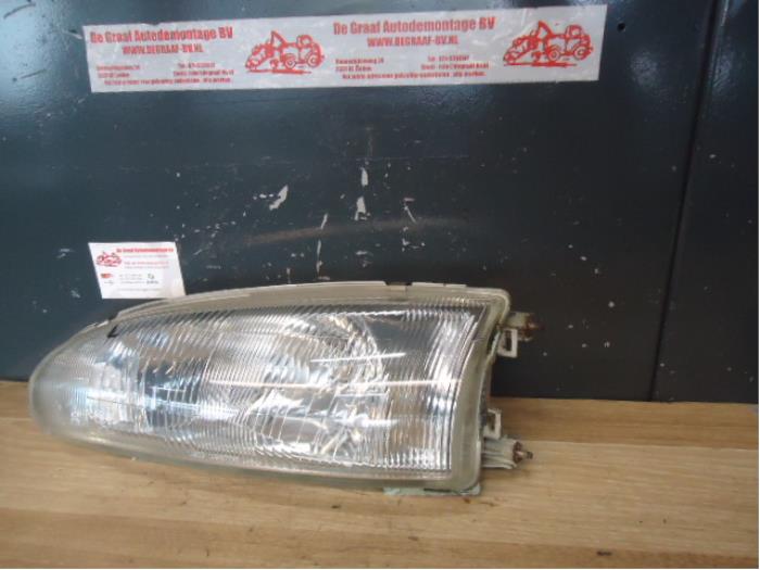 Headlight, left from a Mitsubishi Colt (CA/CC) 1.3 i GL,EL 12V 1994