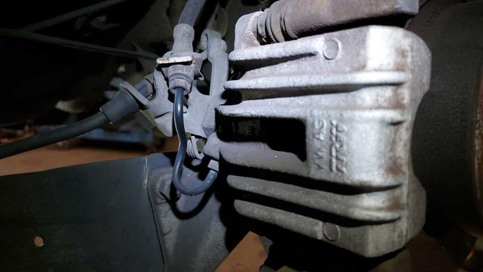 Rear brake calliper, left from a Volkswagen Scirocco (137/13AD) 2.0 TDI 16V 2009