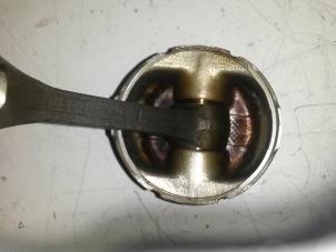 Piston from a Daihatsu Cuore (L251/271/276) 1.0 12V 2001