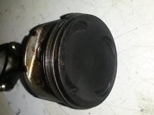 Piston from a Daihatsu Cuore (L251/271/276) 1.0 12V 2001