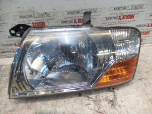 Used Headlight, left Mitsubishi Pajero Price on request offered by N Kossen Autorecycling BV