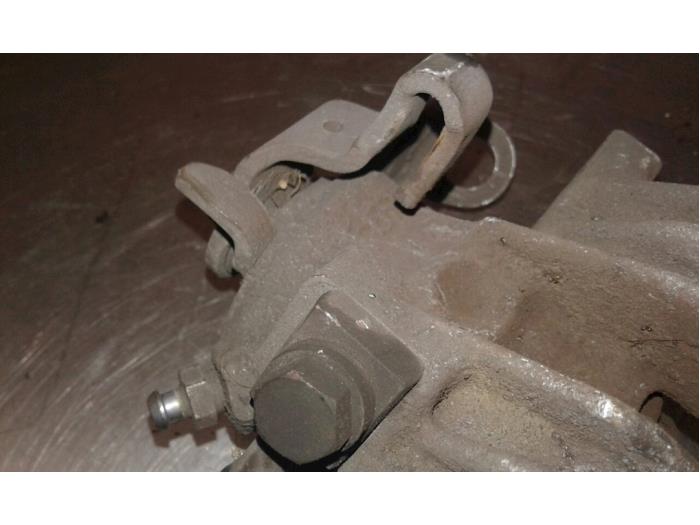 Rear brake calliper, left from a Seat Ibiza ST (6J8) 1.4 16V 2010