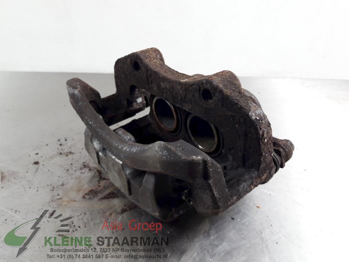 Front brake calliper, left from a Nissan X-Trail (T30) 2.5 16V 4x4 2007