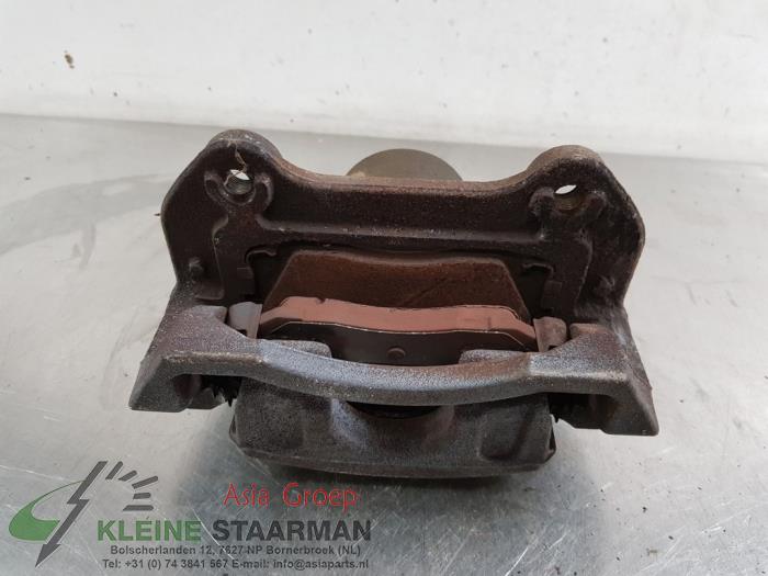 Front brake calliper, left from a Kia Sportage (QL) 1.6 T-GDI 177 16V 4x4 2016