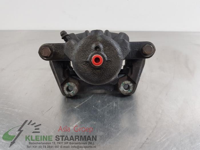 Front brake calliper, left from a Nissan Note (E12) 1.2 DIG-S 98 2016