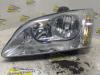 Headlight, left from a Ford Focus 2 Wagon 1.6 Ti-VCT 16V 2005