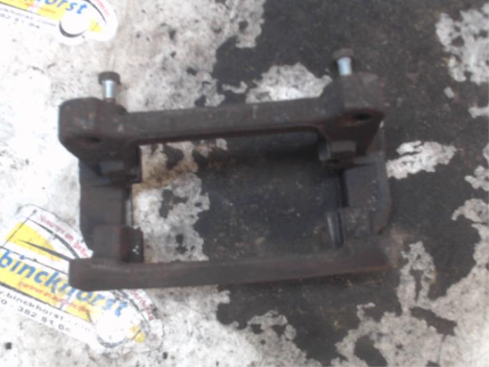 Rear brake calliperholder, left from a Volkswagen Transporter T5 2.0 TDI DRF 2012
