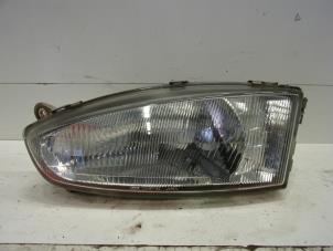 Used Headlight, left Mitsubishi Colt (CJ) 1.3 GL,GLX 12V Price € 40,00 Margin scheme offered by Verhoef Cars & Parts