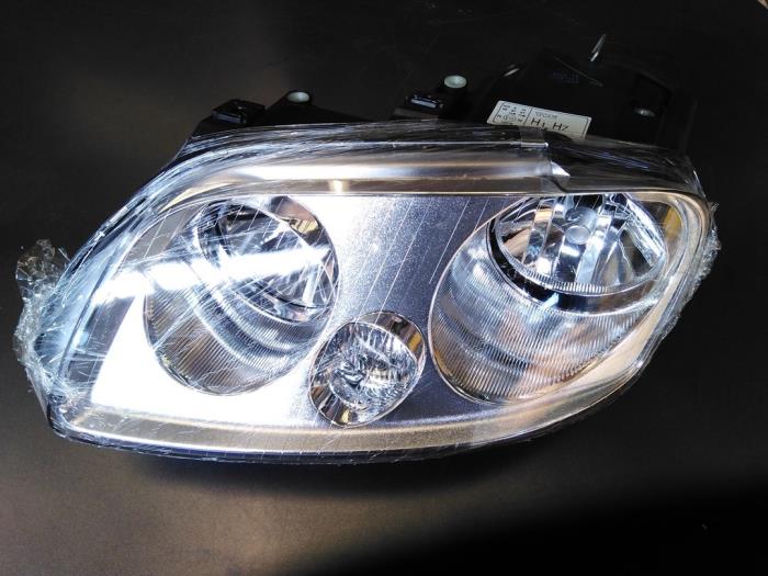 Headlight, left from a Volkswagen Caddy Combi III (2KB,2KJ) 1.9 TDI 2005