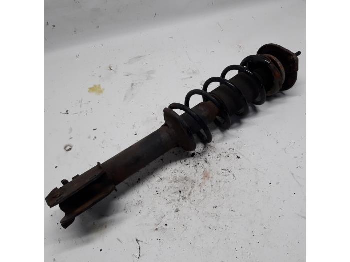 Fronts shock absorber, left from a Daihatsu Cuore (L251/271/276)  2002