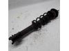 Fronts shock absorber, left from a Daihatsu Cuore (L251/271/276), Hatchback, 2003 2002