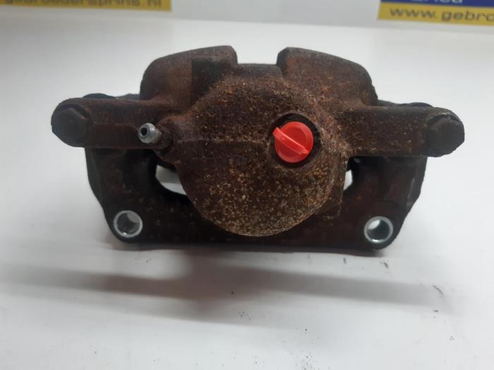 Front brake calliper, left from a Renault Kangoo Express (FW) 1.5 dCi 90 FAP 2014