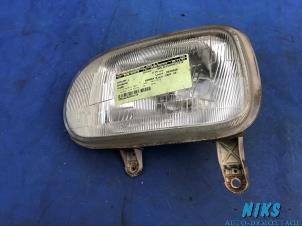 Used Headlight, left Daihatsu Cuore (L251/271/276) 850,Domino Price on request offered by Niks autodemontage