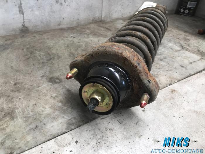 Rear shock absorber rod, left from a Mitsubishi Colt 2003