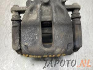 Used Front brake calliper, left Nissan Note (E12) 1.2 68 Price € 39,95 Margin scheme offered by Japoto Parts B.V.