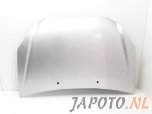 Używane Maska Kia Carens III (FG) 2.0i CVVT 16V Cena € 124,95 Procedura marży oferowane przez Japoto Parts B.V.