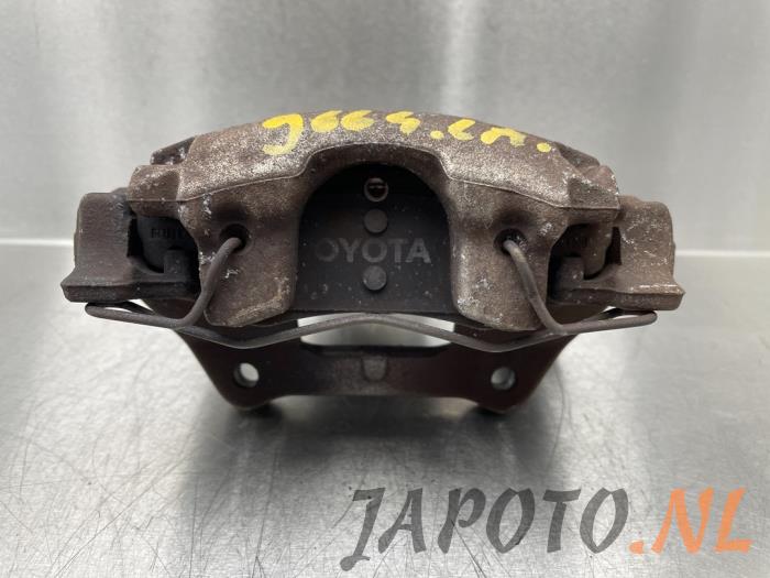 Rear brake calliper, left from a Toyota Yaris III (P13) 1.5 16V Hybrid 2019