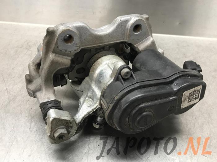 Rear brake calliper, left from a Toyota Yaris IV (P21/PA1/PH1) 1.5 12V Hybrid 2021