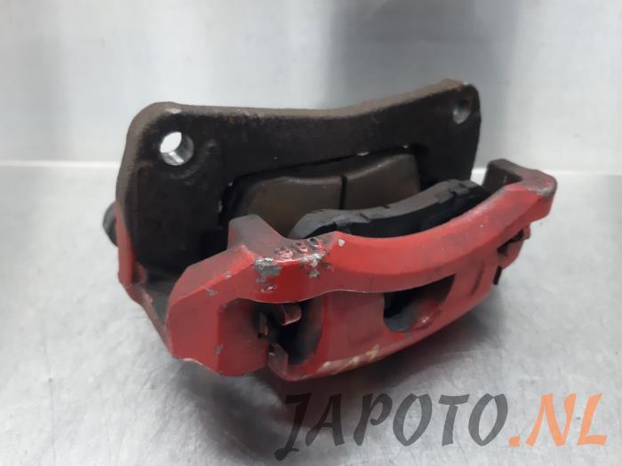 Front brake calliper, left from a Suzuki Swift (ZA/ZC/ZD) 1.2 16V 2011