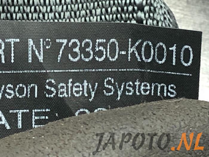 Ceinture de sécurité arrière centre d'un Toyota Yaris IV (P21/PA1/PH1) 1.5 12V Hybrid 2022