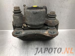 Used Front brake calliper, left Daihatsu Cuore (L251/271/276) 1.0 12V Price € 39,95 Margin scheme offered by Japoto Parts B.V.