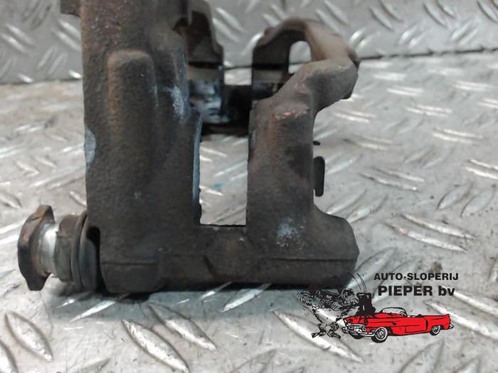 Rear brake calliperholder, left from a Volkswagen Golf VI Variant (AJ5/1KA) 1.2 TSI BlueMotion 2010