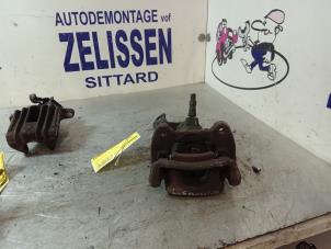 Used Rear brake calliper, left Mini Mini (R56) 1.6 16V One Price € 42,00 Margin scheme offered by Zelissen V.O.F. autodemontage