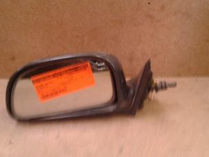 Used Wing mirror, left Mitsubishi Colt (CA/CC) 1.3 i GL,EL 12V Price on request offered by Akkie Stomphorst Autodemontage
