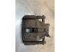 Front brake calliper, left from a Renault Clio III (BR/CR) 1.5 dCi 85 2007