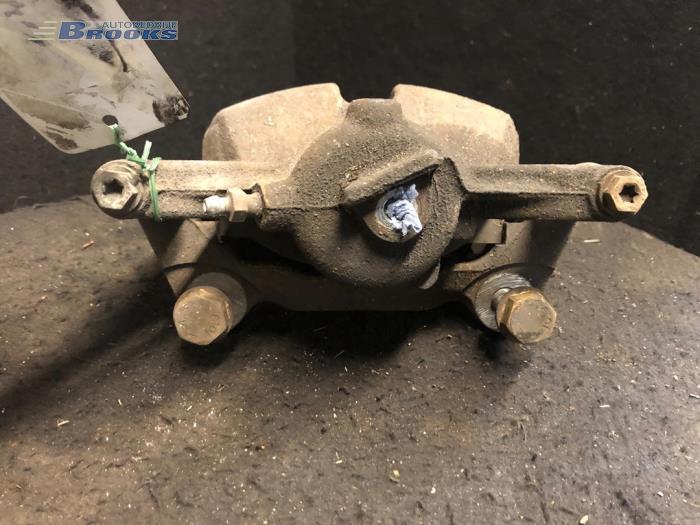 Front brake calliper, left from a Volkswagen Golf VII (AUA) 1.6 TDI BlueMotion 16V 2014