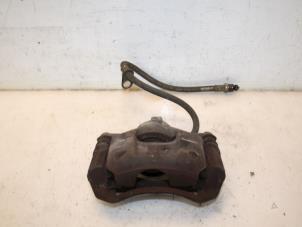 Used Front brake calliper, left Peugeot 107 Price € 30,00 Margin scheme offered by Van Gils Automotive