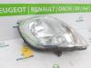Headlight, left from a Renault Trafic New (FL) 1.9 dCi 82 16V 2003