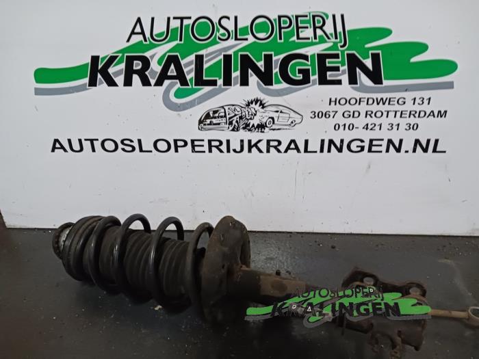 Fronts shock absorber, left from a Opel Corsa D 1.2 16V 2006