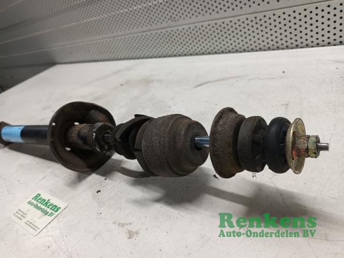 Rear shock absorber, left from a Mazda Demio (DW) 1.3 16V 1999