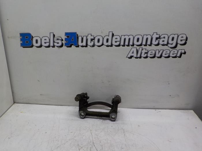 Rear brake calliperholder, left from a Volkswagen Transporter T5 1.9 TDi 2009