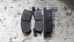 Used Front brake pad Daihatsu Cuore (L251/271/276) 1.0 12V DVVT Price on request offered by Autodemontage Joko B.V.