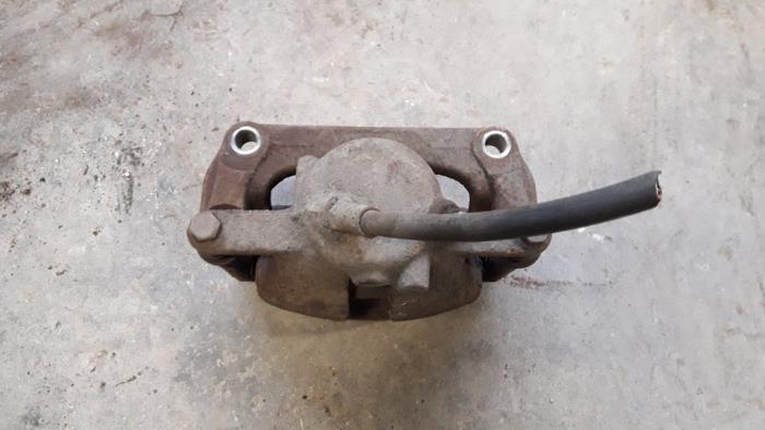 Front brake calliper, left from a Renault Kangoo Express (FW) 1.5 dCi 75 2010