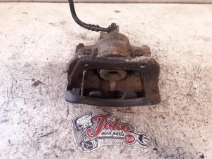 Used Front brake calliper, left Opel Tigra Twin Top 1.8 16V Price on request offered by Autodemontage Joko B.V.