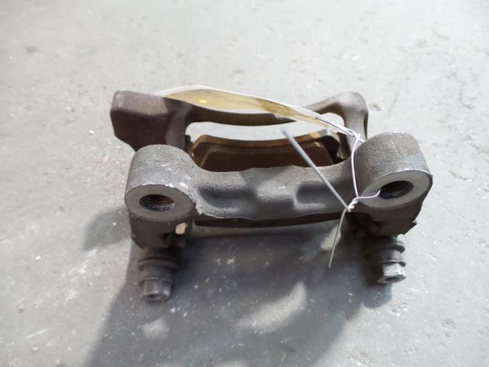 Rear brake calliperholder, left from a Volkswagen Passat (3C2) 2.0 TDI 16V 140 2009