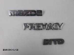 Używane Emblemat Mazda Premacy 2.0 DiTD 16V Cena € 7,50 Procedura marży oferowane przez Autobedrijf Broekhuis B.V.