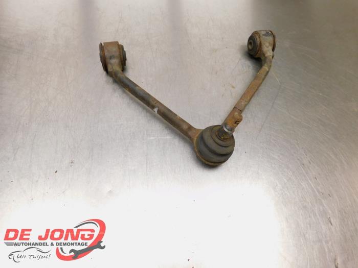 Front upper wishbone, left from a SsangYong Rexton W 2.0 e-200 Xdi 16V 2WD 2013