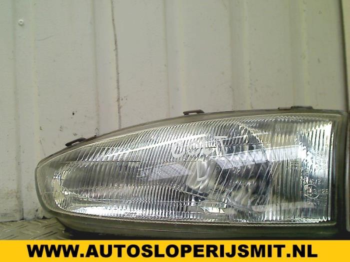 Headlight, left from a Mitsubishi Colt (CA/CC) 1.3 i GL,EL 12V 1993