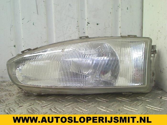 Headlight, left from a Mitsubishi Colt (CA/CC) 1.6 i GL,GLX 16V 1994