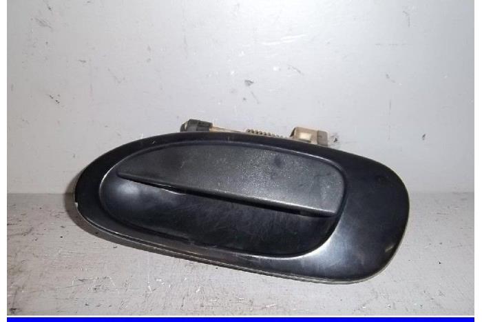 Rear door handle 4-door, left from a Mazda 323 (BA12) 1.8i 16V 1997
