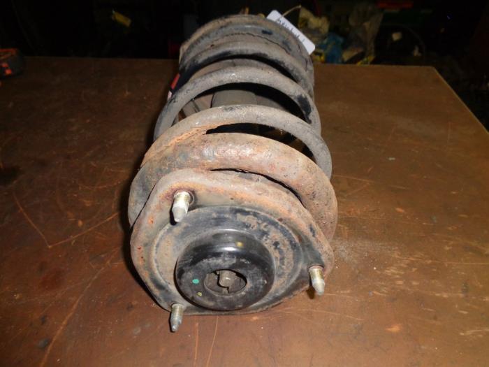 Fronts shock absorber, left from a Mitsubishi Space Star (DG) 1.3 16V 2002